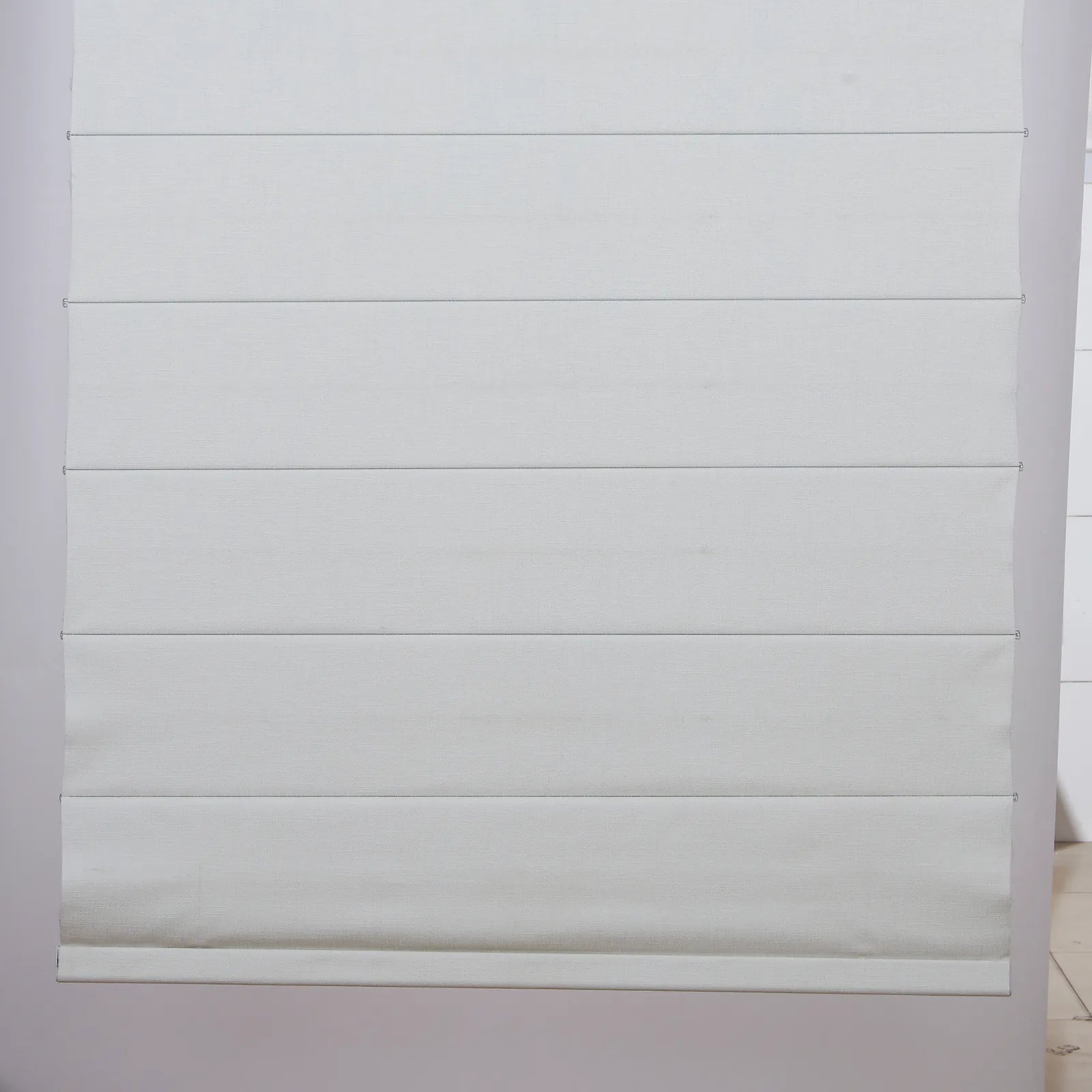 Cloud White Roman shade fold and lower rail detail