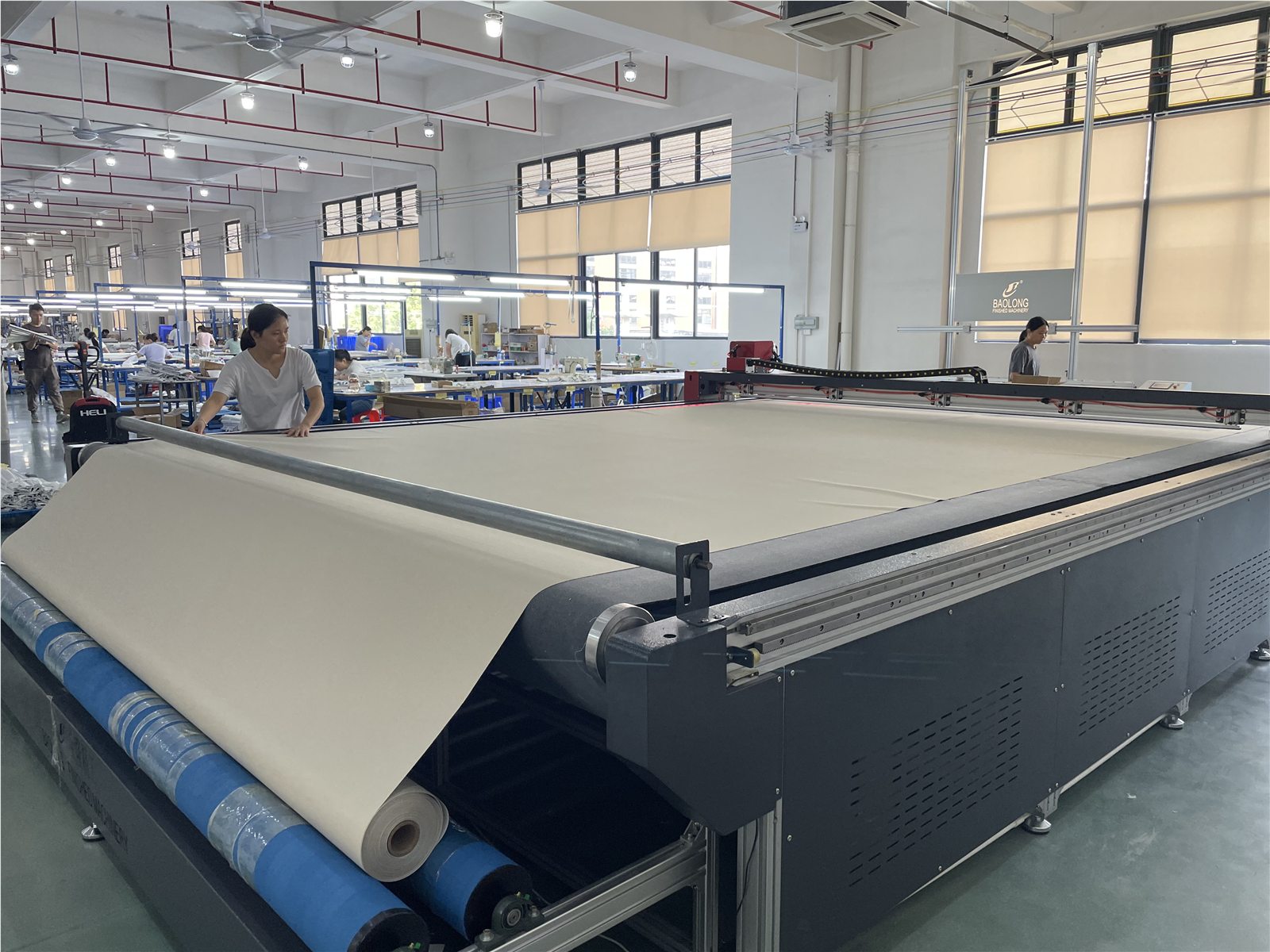 Fabric being prepared on a large cutting table in the factory